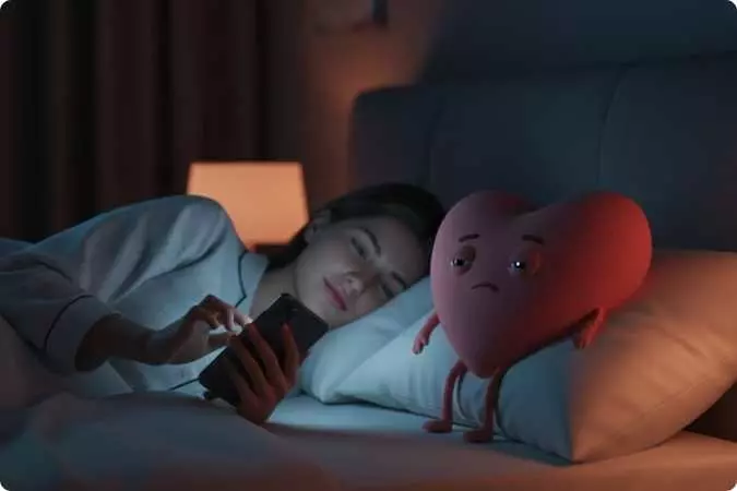 Mulher usando celular à noite na cama enquanto a luz azul da tela afeta o descanso, representando o impacto do uso de telas no estilo de vida moderno.